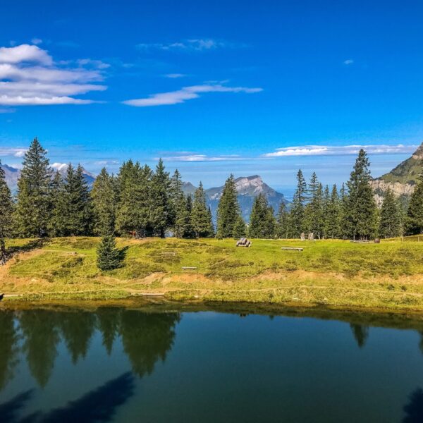 Fleschsee (Eggberge) mit Bergpanorama und Spiegelung im Wasser