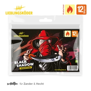 Die Verpackung des Angelköders Black Shadow 12,5 cm zeigt eine Cartoon-Figur mit rotem Hut und Kopftuch, die einen fischförmigen Köder hält. Der Text hebt die Größe von 12,5 cm und die Zielfische - Zander und Hecht - hervor.