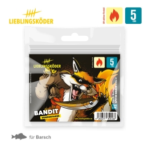 Der Bandit 5cm Lieblingsköder kommt in einer weißen Verpackung mit gelben und roten Akzenten, auf der ein Fuchs abgebildet ist, der einen Köder hält. Auf dem Etikett stehen "5 cm", eine Flamme und Fischsymbole, die darauf hinweisen, dass er ideal für Barsche ist.