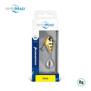 Verpackter Jigmaster Charly 8g Angelköder von SpinMad, gelb und schwarz mit einem silbernen Spinner. Auf der Verpackung befindet sich das SpinMad-Logo in der oberen linken und unteren rechten Ecke.