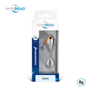 Ein verpackter Jigmaster Captain 8g Angelköder, silber mit orangefarbenem Akzent, wird in einer weiß-blauen Schachtel mit SpinMad-Logos auf der Verpackung und im Hintergrund präsentiert.