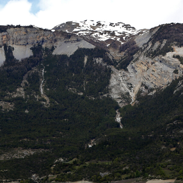 Berglandschaft mit Schnee auf den Gipfeln und Waldhängen. Gulantschi im Hintergrund.