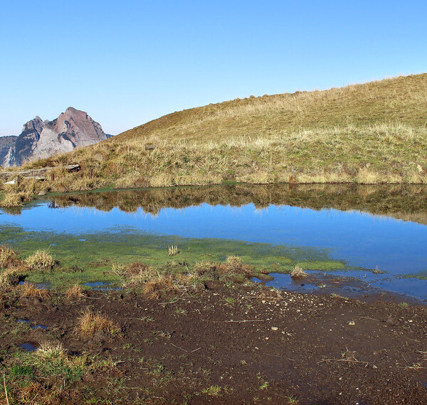 Stoosbach Spiegelung. Bergsee mit Spiegelbild der umliegenden Berge in der Schweiz.