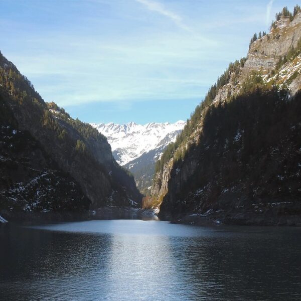 Gigerwaldsee mit Bergen und Schnee. Ruhige Landschaft.