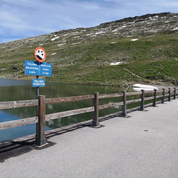 Märjelensee: See mit Verbotsschildern und Weg am Ufer. 